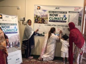 Caption 7 Women farmers signing the climate action pledge wall